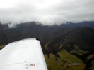 Approaching Mt. Beauty through valley - surrounding mountains covered in clouds